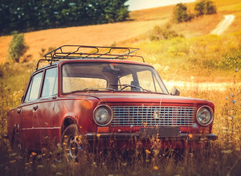 classic red car on grass field