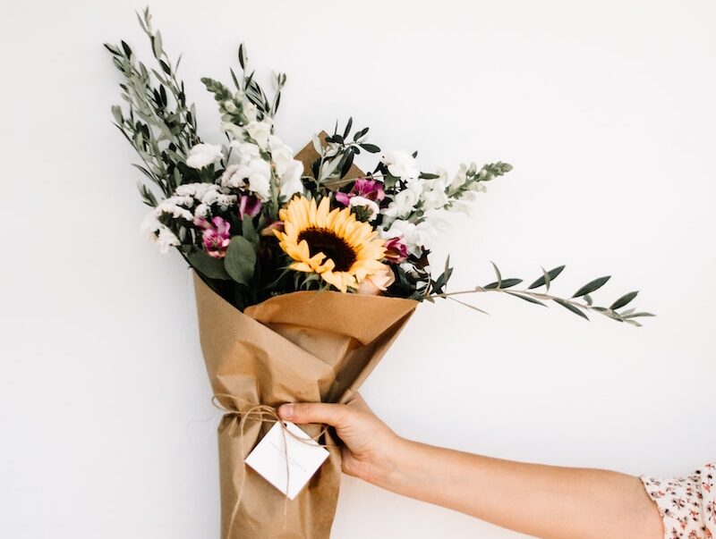 person holding bouquet of flowers
