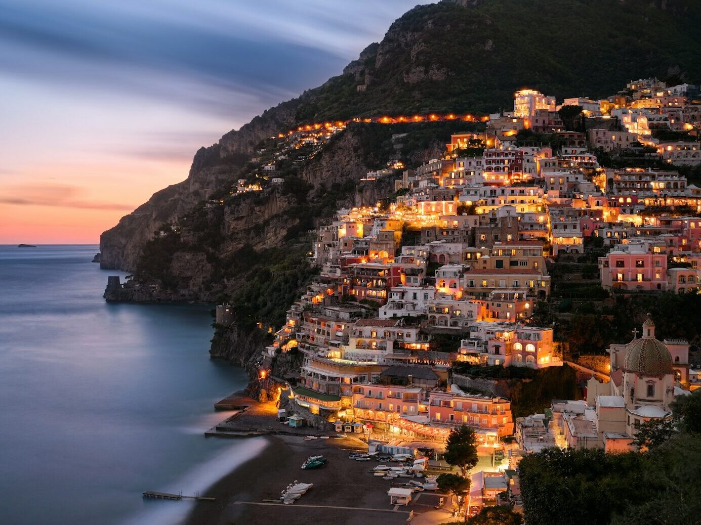 city buildings on mountain near body of water during daytime