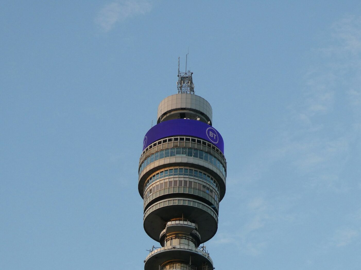 a very tall tower with a blue sign on it's side