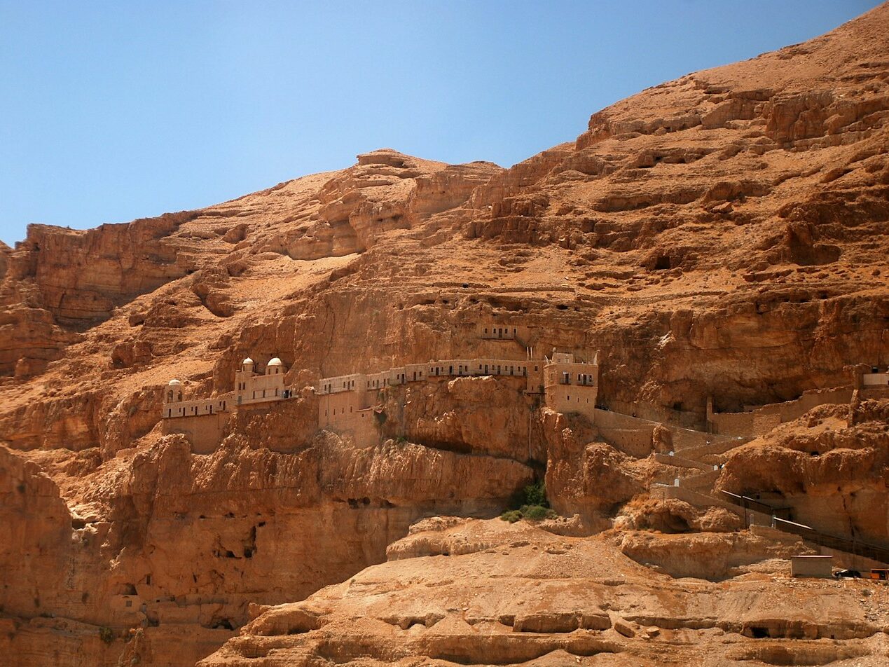 brown rock formations and cave during daytime