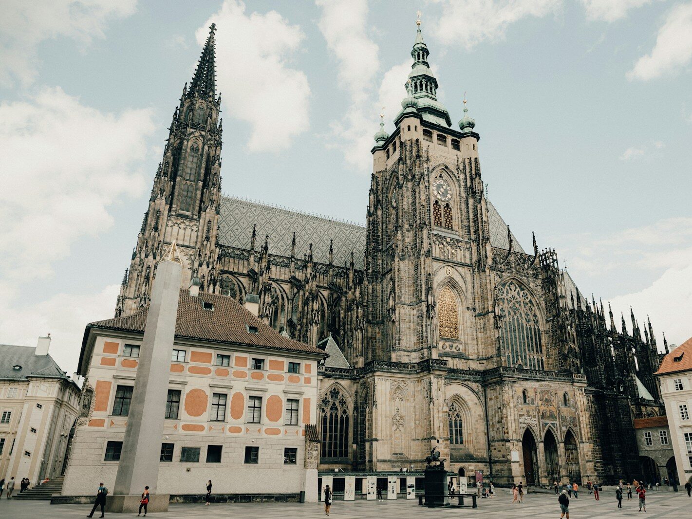 brown and white concrete building under white clouds during daytime